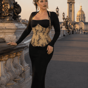 Mannequin femme taille L portant un corset steampunk doré fleuri noir à licou avec une robe noire longue ajustée au pont Alexandre III à Paris.
