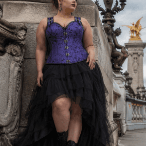 corset steampunk violet en brocart jacquard à motifs baroques avec dos haut, fermeture à crochets métalliques sur le devant et bretelles réglables, porté avec une jupe asymétrique en tulle noir au pont Alexandre III à Paris