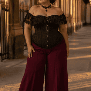 Femme de 40 ans portant un corset noir à dentelle grande taille avec pantalon palazzo bordeaux a la galerie valois a Paris à la golden hour.